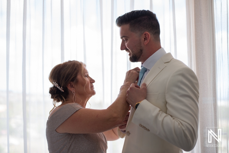 Groom with mom getting ready