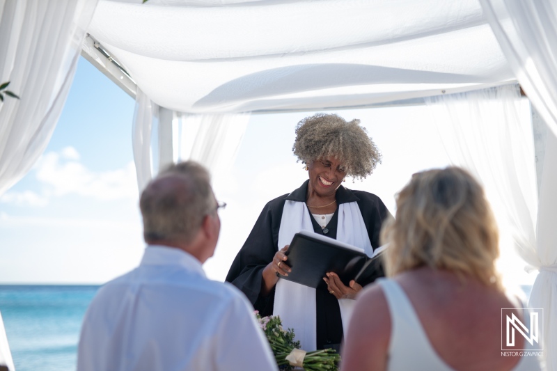 Beautiful wedding ceremony at Playa Porto Mari in Curacao with joyful couple and officiant