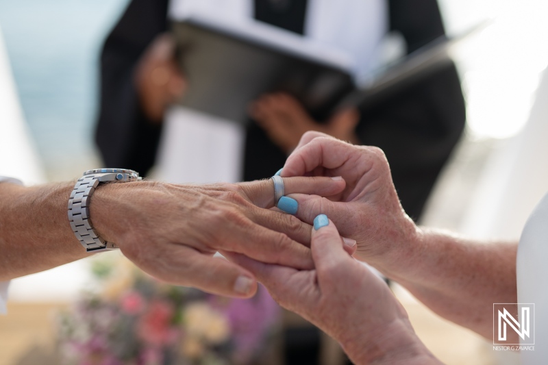 Couple exchanges wedding rings during a beautiful ceremony in Curacao at Playa Porto Mari