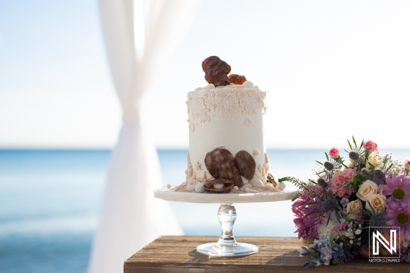 Wedding cake display at Playa Porto Mari in Curacao during a romantic beach ceremony