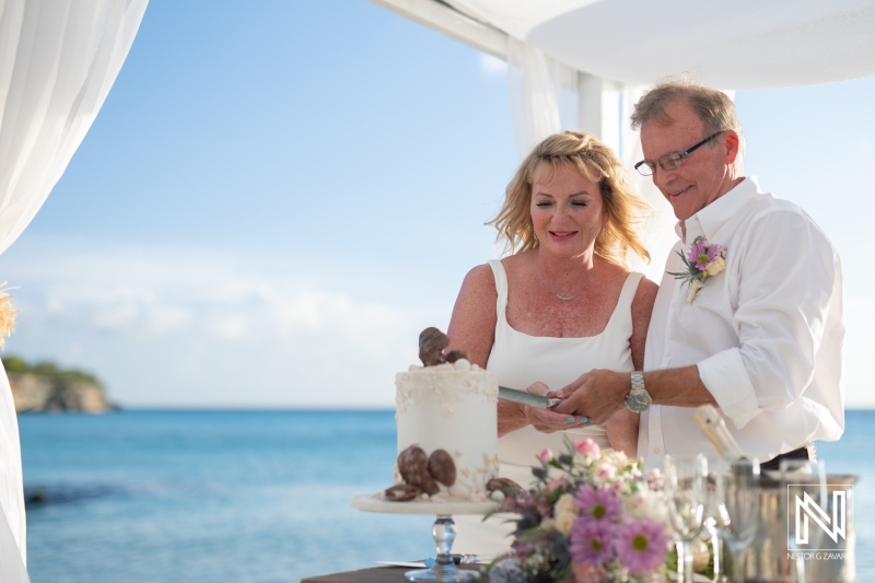 Couple enjoying a romantic wedding celebration at Playa Porto Mari in Curacao with ocean backdrop and elegant decor