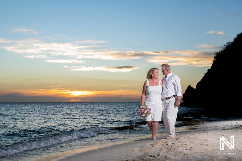 Couple celebrates their wedding on the picturesque shores of Playa Porto Mari in Curacao during a beautiful sunset