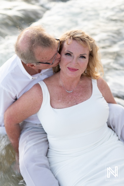 Couple enjoys a romantic moment by the sea during their wedding at Playa Porto Mari in Curacao