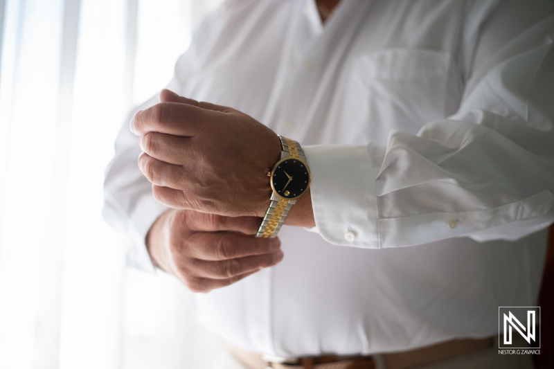 Groom getting into attire