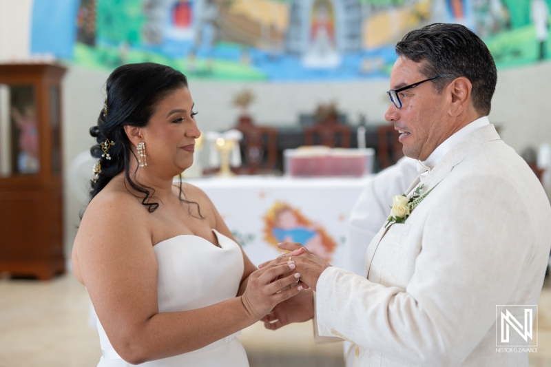 Couple exchanging vows during a beautiful wedding ceremony in Curacao surrounded by friends and family in a vibrant setting