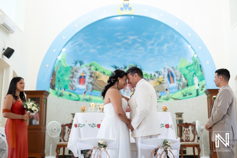 Couple exchanges vows in a beautiful wedding ceremony in Curacao with vibrant mural backdrop