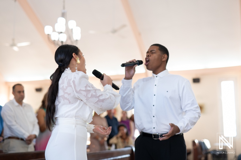 Couple shares heartfelt vows during their wedding ceremony in Curacao while guests witness their devotion