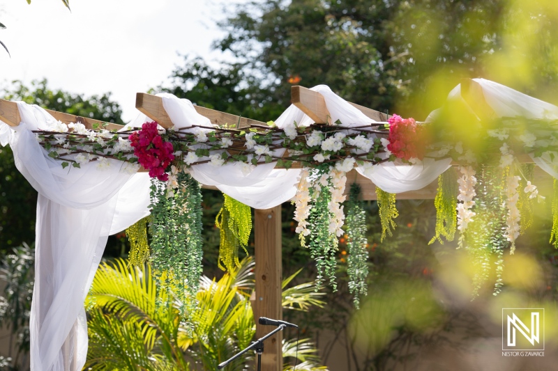 Beautiful wedding altar adorned with flowers and greenery in Curacao for a romantic celebration on a sunny day