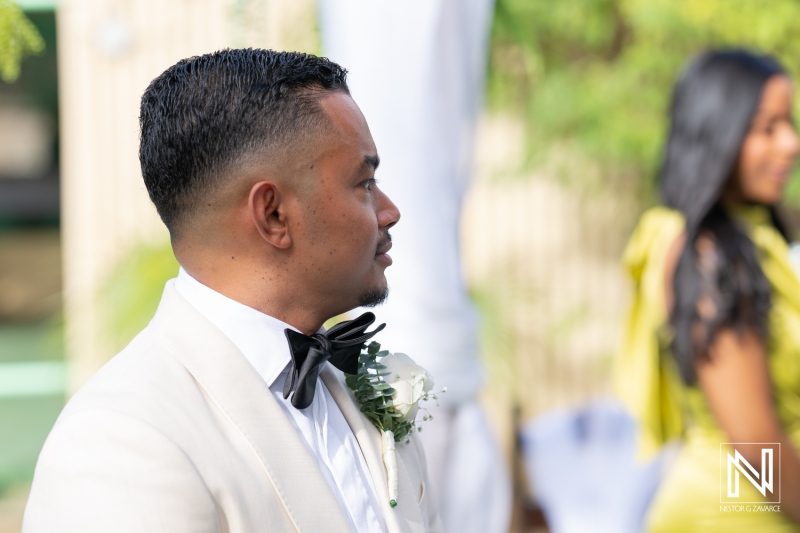 Groom awaiting his bride during a beautiful wedding ceremony in Curacao, celebrating love amidst stunning tropical scenery