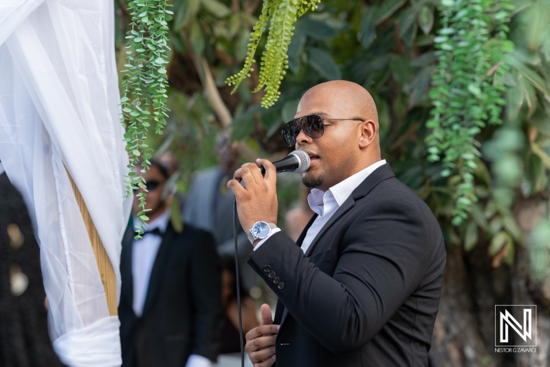 Musician performing at a wedding celebration in Curacao during a beautiful outdoor ceremony