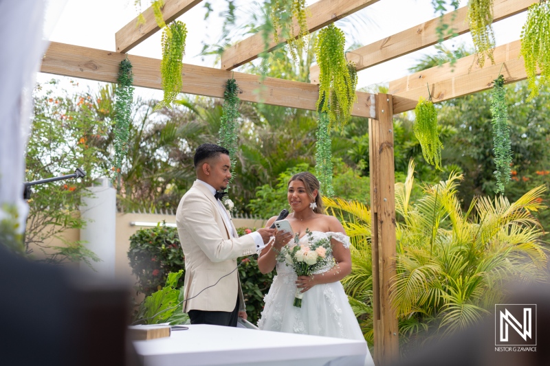 Ceremony of love under a natural arch in Curacao surrounded by vibrant greenery
