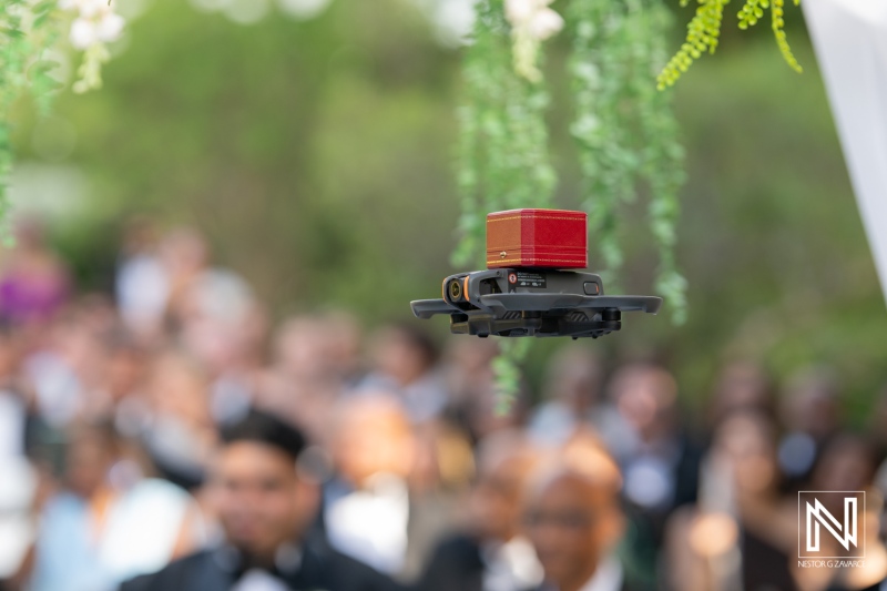 Wedding celebration in Curacao featuring a unique drone carrying special moments during the ceremony amidst a romantic setting