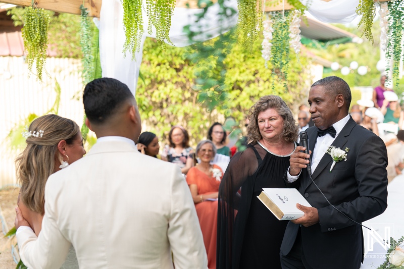 Celebration of love at a beautiful wedding in Curacao amidst greenery and an elegant setup with guests in attendance