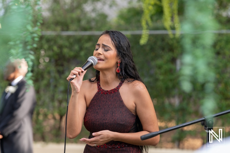 Wedding singer captivating guests during a ceremony in Curacao with heartfelt performance