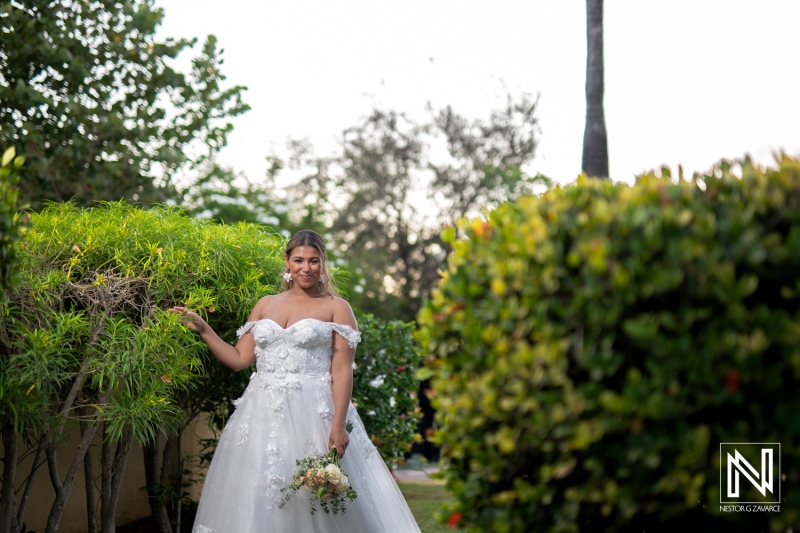 Wedding celebration in Curacao featuring a bride in a beautiful gown surrounded by lush greenery
