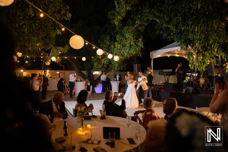 Celebration of love during a beautiful wedding in Curacao with friends and family gathered for the first dance under twinkling lights