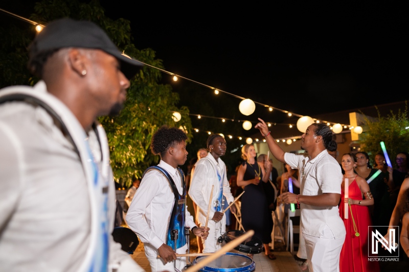 Vibrant celebration at a wedding in Curacao featuring lively drummers and joyful guests on a beautiful night