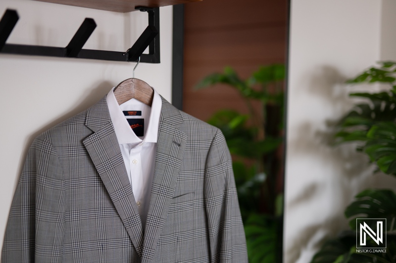 Elegant wedding preparation at Avila Beach Hotel in Curacao with stylish suit on display