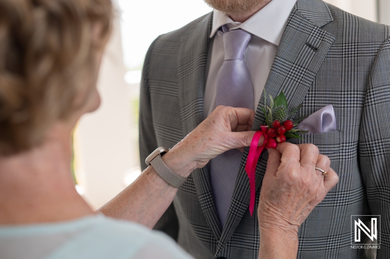 Wedding preparation at Avila Beach Hotel in Curacao with a focus on corsage placement and elegant attire