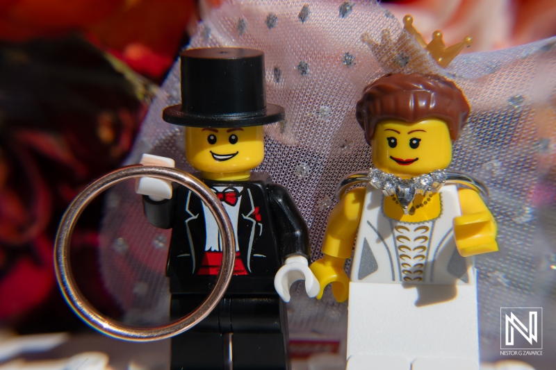 Wedding celebration at Avila Beach Hotel in Curacao featuring unique Lego couple and elegant ring display