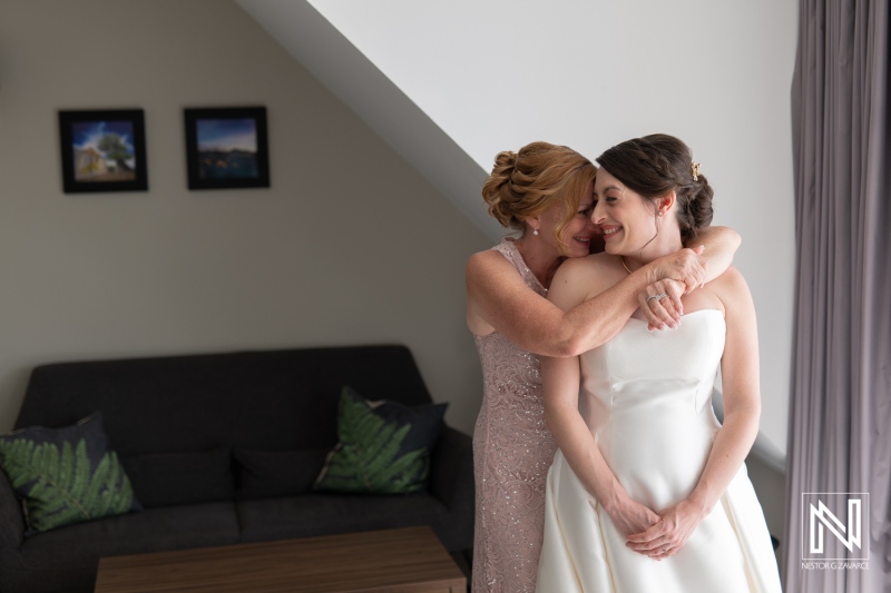 Joyful moments before the wedding ceremony at Avila Beach Hotel in Curacao with bride and her mother sharing a heartfelt embrace
