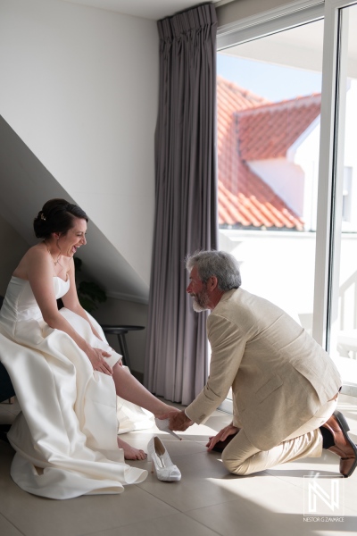 Joyful bride prepares for wedding ceremony at Avila Beach Hotel in Curacao, creating unforgettable moments with her father