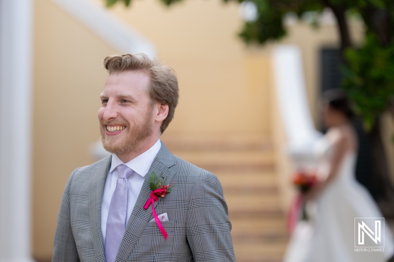 Groom smiling with joy at a wedding ceremony at Avila Beach Hotel in Curacao surrounded by beautiful scenery
