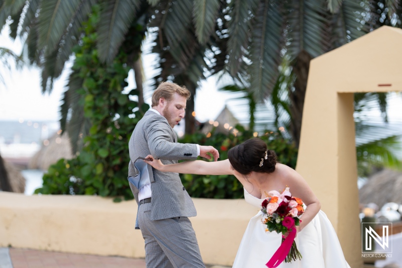 Couple exchanges joyful moments during their wedding ceremony at Avila Beach Hotel in Curacao