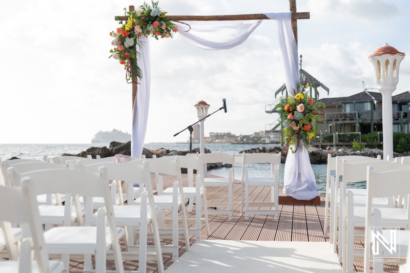 Beautiful wedding ceremony setup at Avila Beach Hotel in Curacao with ocean backdrop and floral decorations