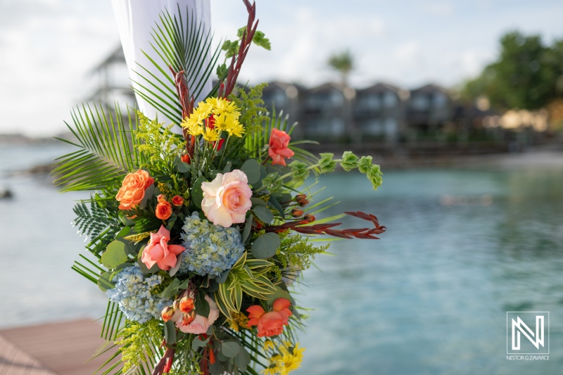 Wedding floral arrangement at Avila Beach Hotel in Curacao showcases vibrant colors against the serene ocean backdrop