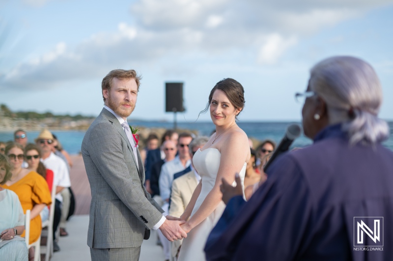 Couple exchanges vows during a beautiful wedding ceremony at Avila Beach Hotel in Curacao with stunning ocean backdrop