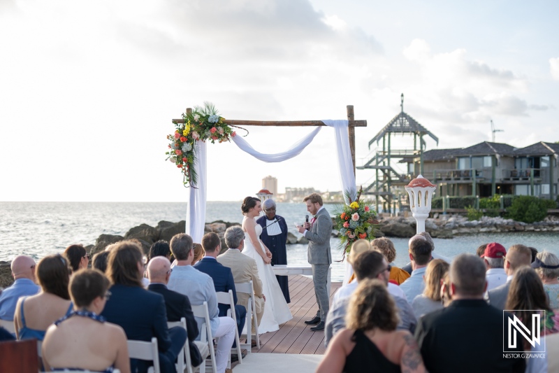 Beautiful wedding ceremony at Avila Beach Hotel in Curacao with ocean view and floral decorations in a tropical setting