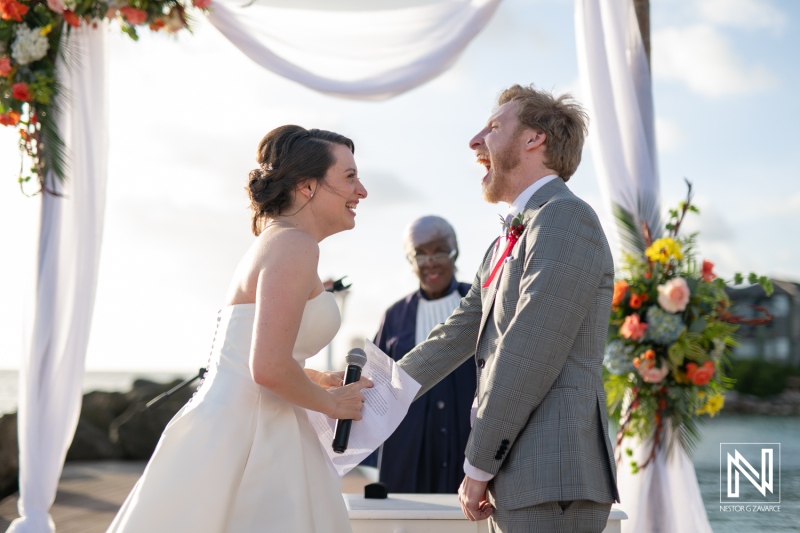 Romantic wedding ceremony in Curacao at Avila Beach Hotel with joyful couple exchanging vows during sunset
