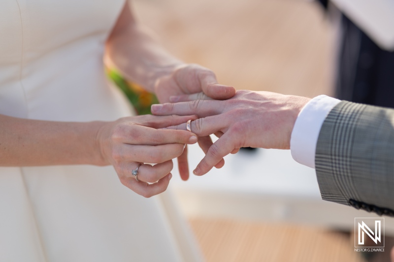 Beautiful wedding ceremony at Avila Beach Hotel in Curacao where the couple exchanges rings, symbolizing their love and commitment