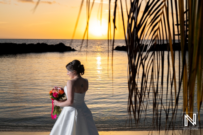 Beautiful sunset wedding moment at Avila Beach Hotel in Curacao captures the joy and elegance of a bride embracing a tropical paradise