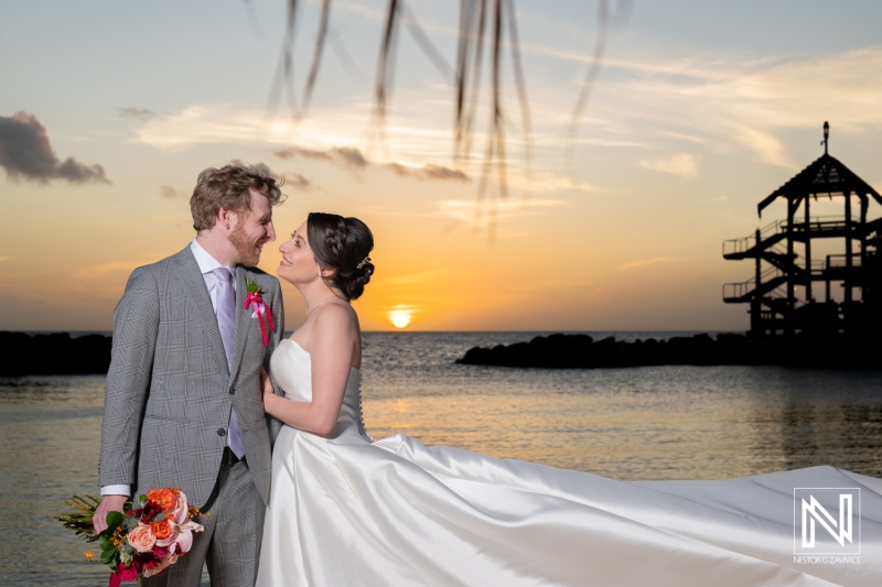 Couple celebrates their wedding at Avila Beach Hotel in Curacao during a beautiful sunset