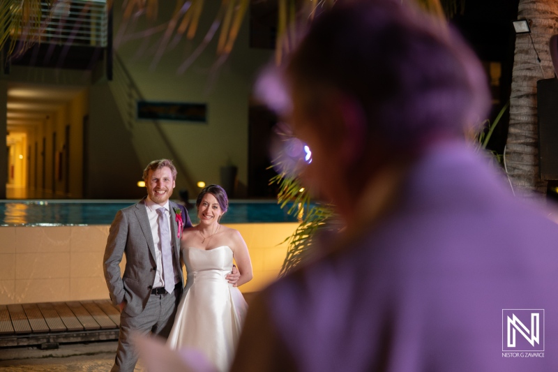 Couple celebrating their wedding at Avila Beach Hotel in Curacao with a beautiful evening backdrop and a heartfelt ceremony