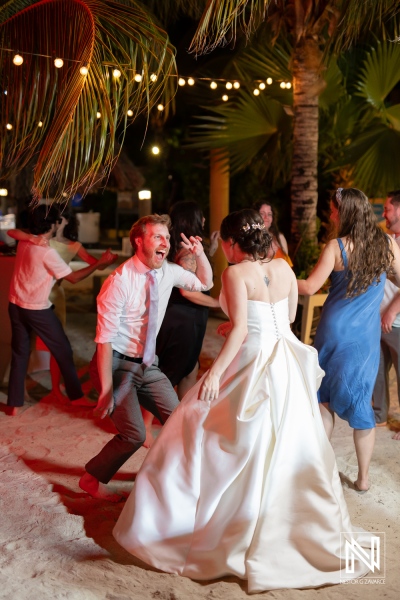 Celebration at Avila Beach Hotel in Curaçao features joyful couple dancing during an enchanting wedding reception