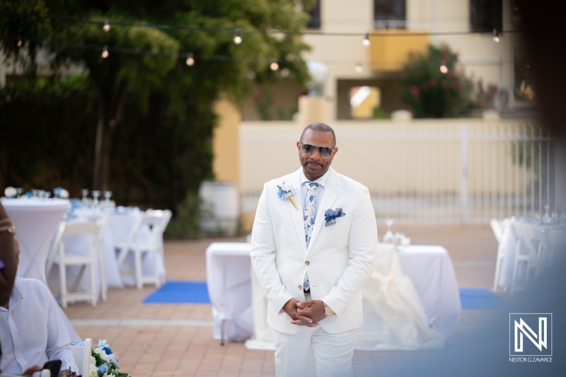 Groom waits for bride during wedding ceremony at Avila Beach Hotel in Curacao under sunny skies
