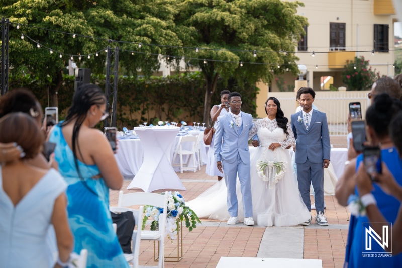 Wedding ceremony at Avila Beach Hotel with bride and family walking down the aisle in Curacao