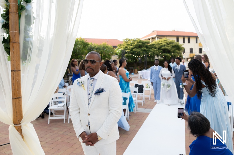 Wedding ceremony takes place at Avila Beach Hotel in Curacao with guests and wedding party present