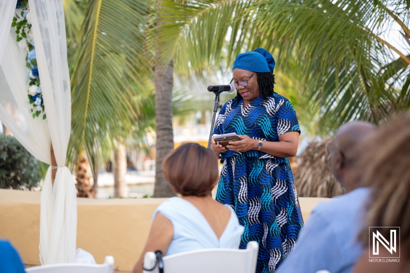 Wedding ceremony takes place at Avila Beach Hotel in Curacao with guests enjoying the moment and a speaker addressing the crowd