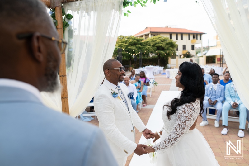 Wedding ceremony taking place at Avila Beach Hotel in Curacao with guests seated in the background during the event