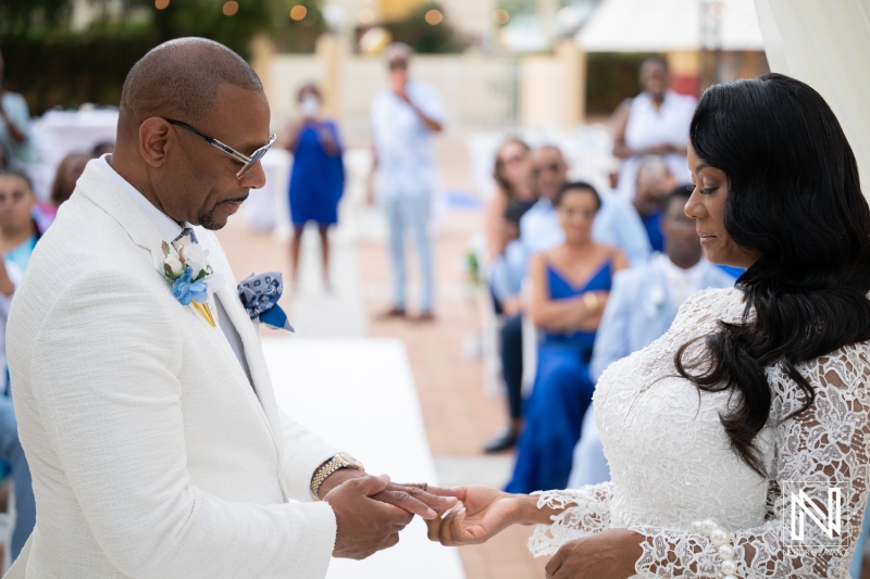 Wedding ceremony at Avila Beach Hotel with couple exchanging rings during vows near the beach