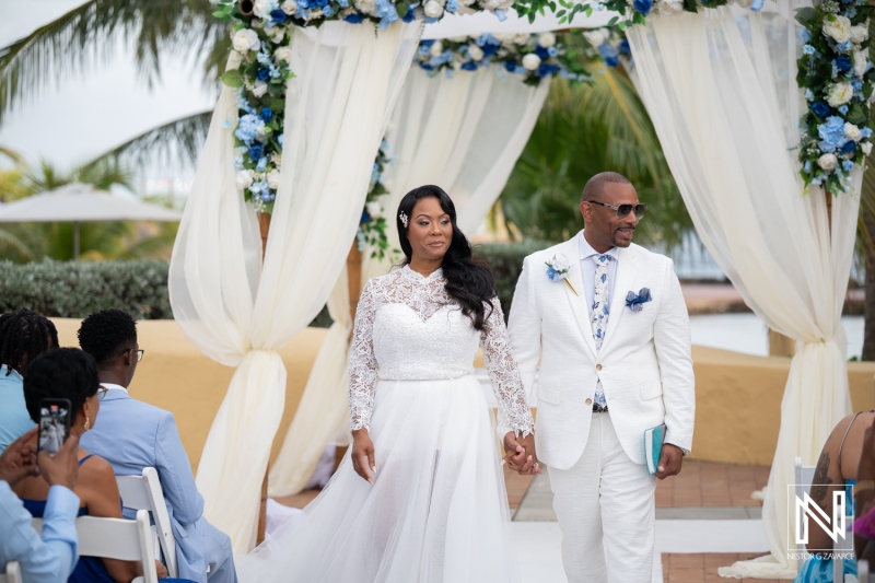 Wedding ceremony at Avila Beach Hotel in Curacao with couple walking together after vows taken