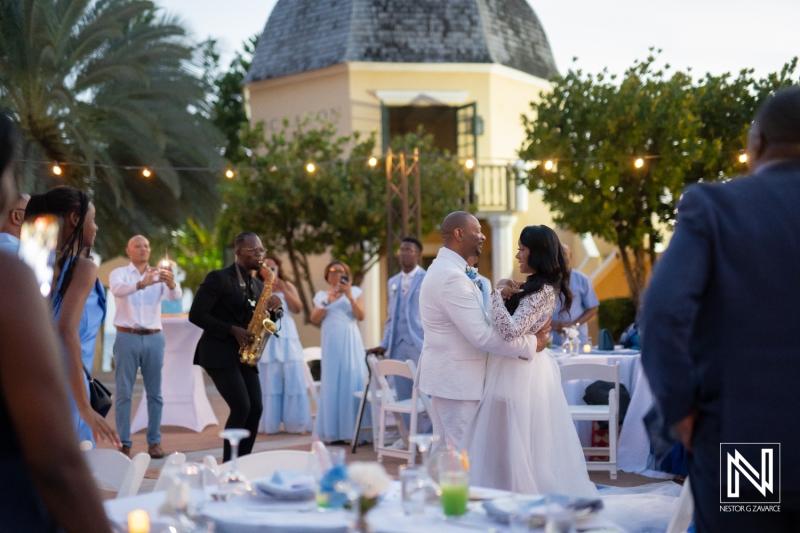 Couples dance during wedding reception at Avila Beach Hotel in Curacao at sunset with guests enjoying the celebration