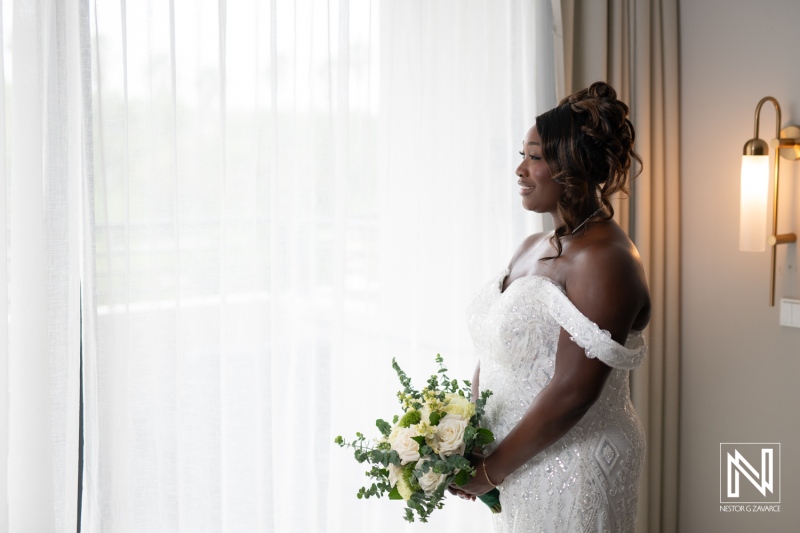 Beautiful bride in wedding attire prepares for ceremony at Mangrove Beach Corendon in Curacao during a sunny day