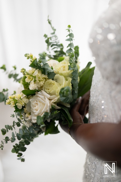 Elegant bride holding a beautiful bouquet at Mangrove Beach Corendon during a romantic wedding in Curacao