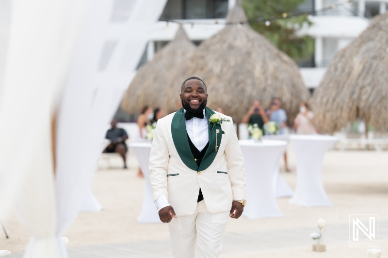 Celebration of love at Mangrove Beach Curacao showcases joyful groom in white suit at tropical wedding venue