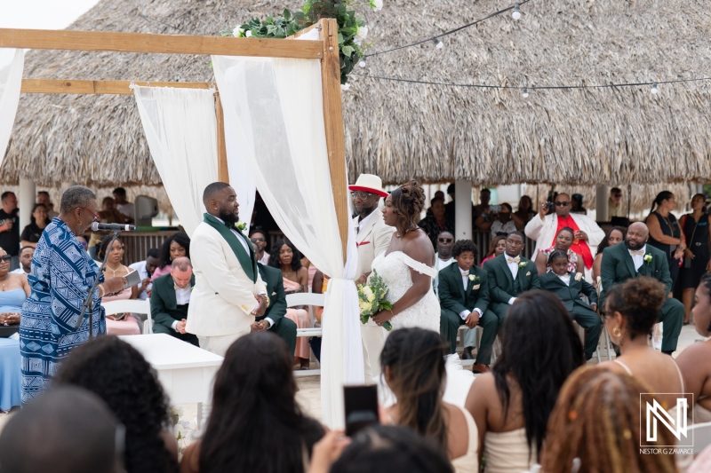 Beautiful wedding ceremony taking place at Mangrove Beach Corendon in Curacao during a sunny afternoon with family and friends gathered